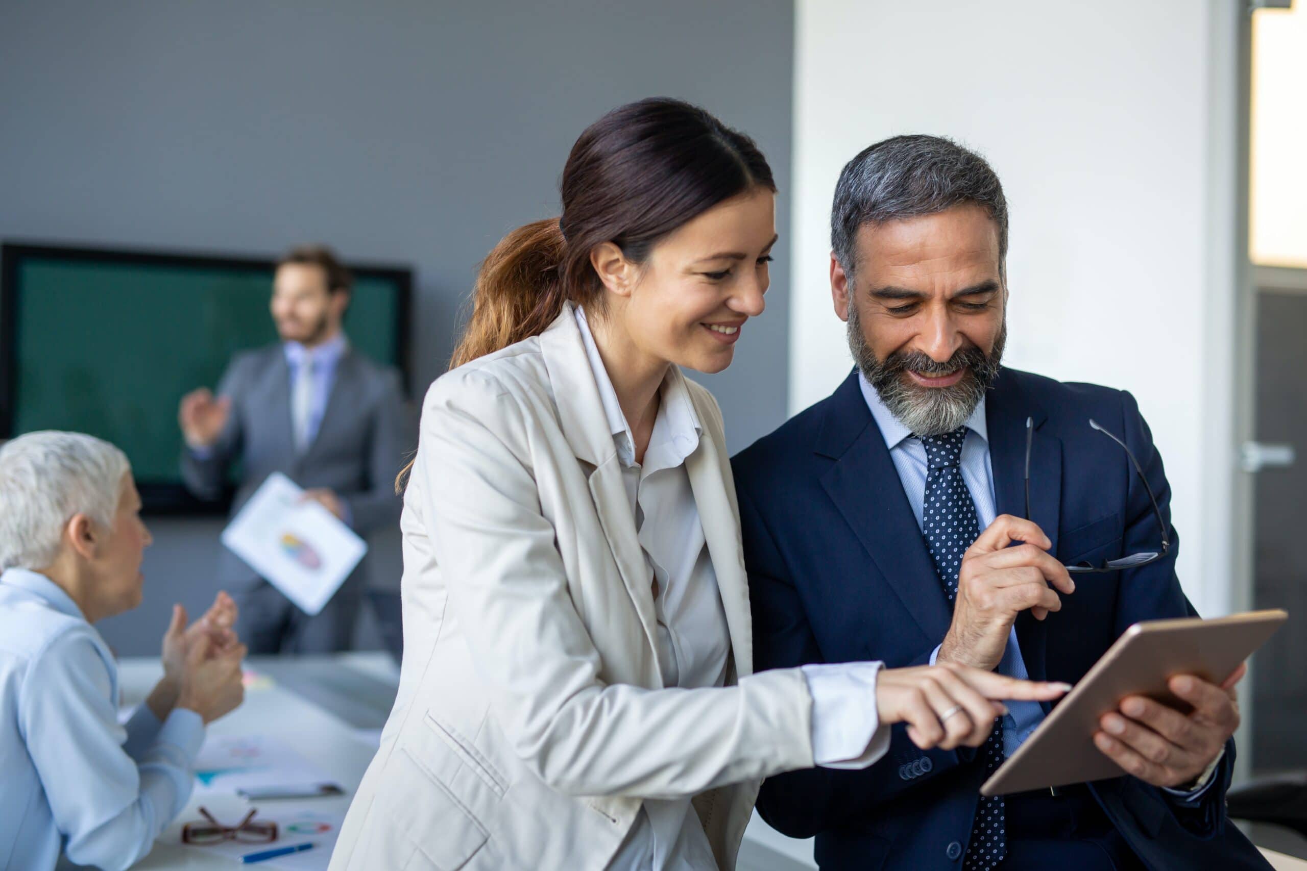 Two business leaders looking at tablet displaying serverless security cameras