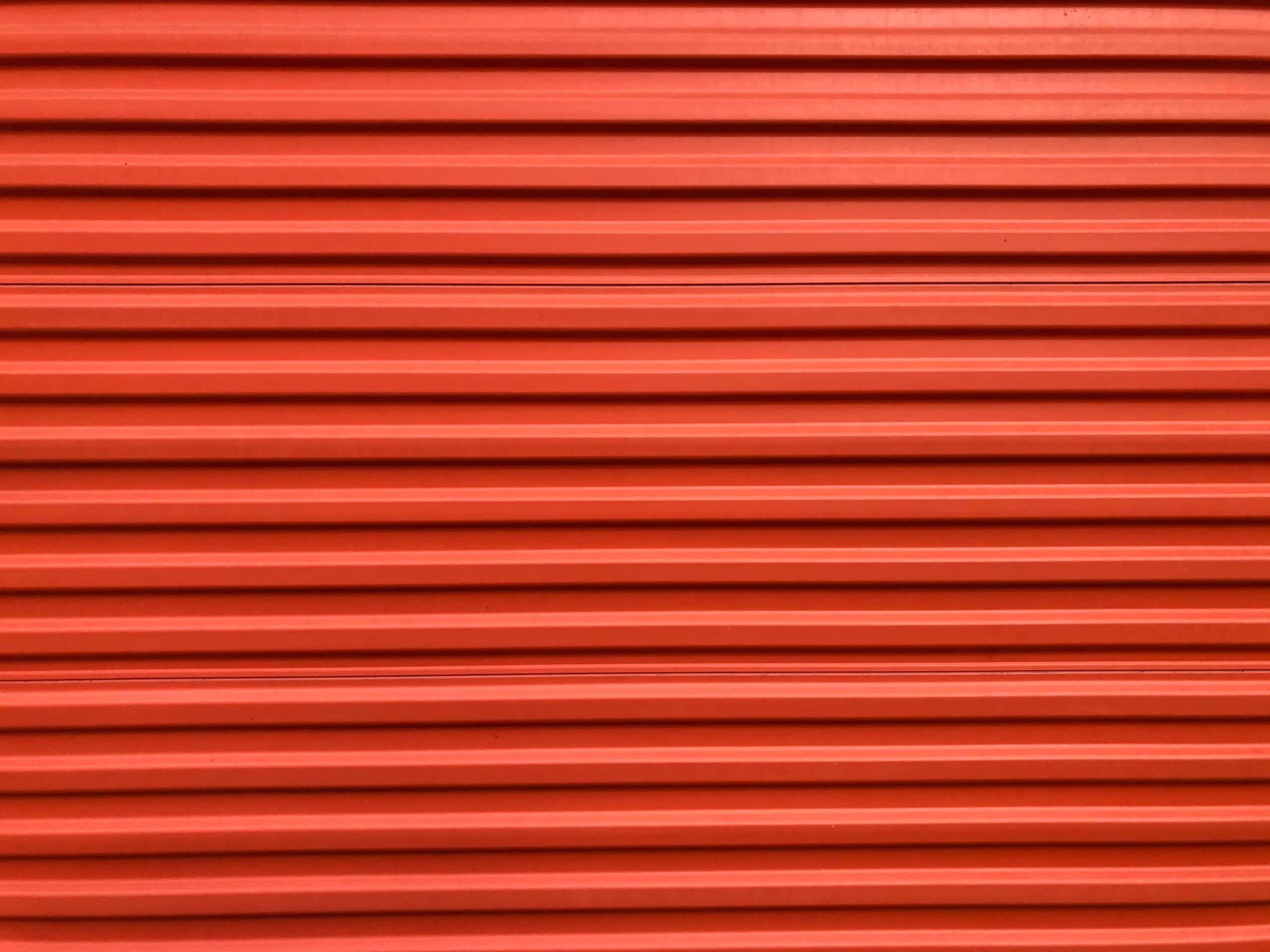 Roll-up steel sheet door of a self-storage unit that has a security camera system